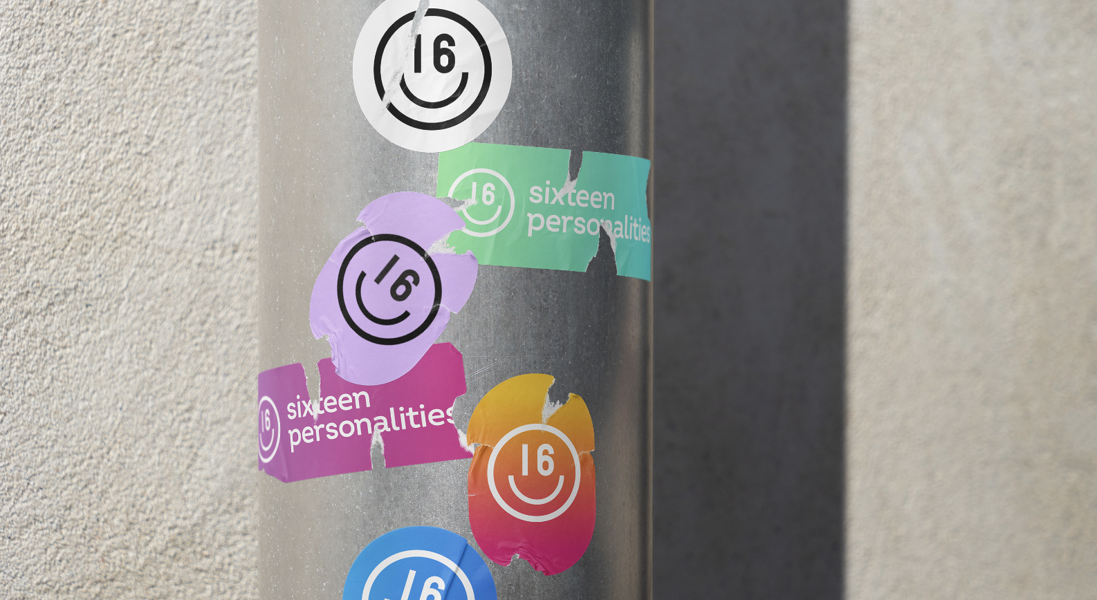 Colorful 16 Personalities stickers applied to a street pole